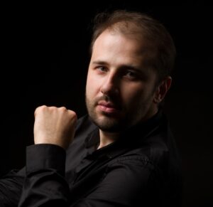 Portrait of Ukrainian pianist Stanislav Khristenko with a dark background
